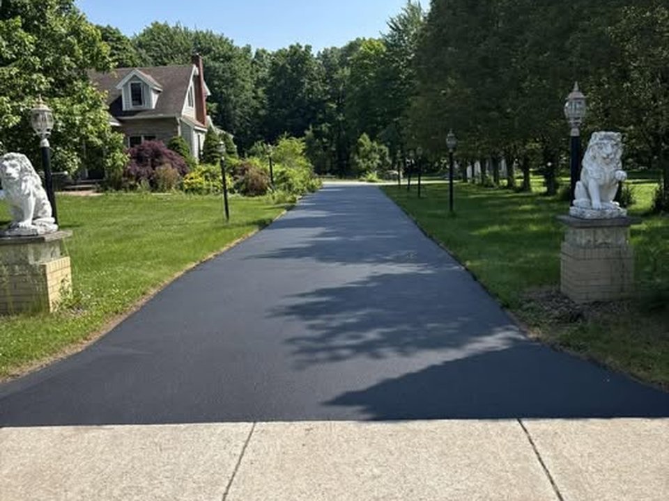 Completed asphalt sealing job on a Rochester, NY driveway by Bold Seal