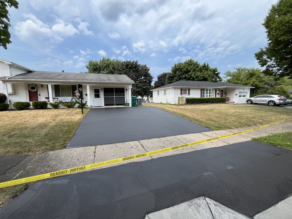 Freshly sealed residential driveway in a Monroe County, NY subdivision by Bold Seal